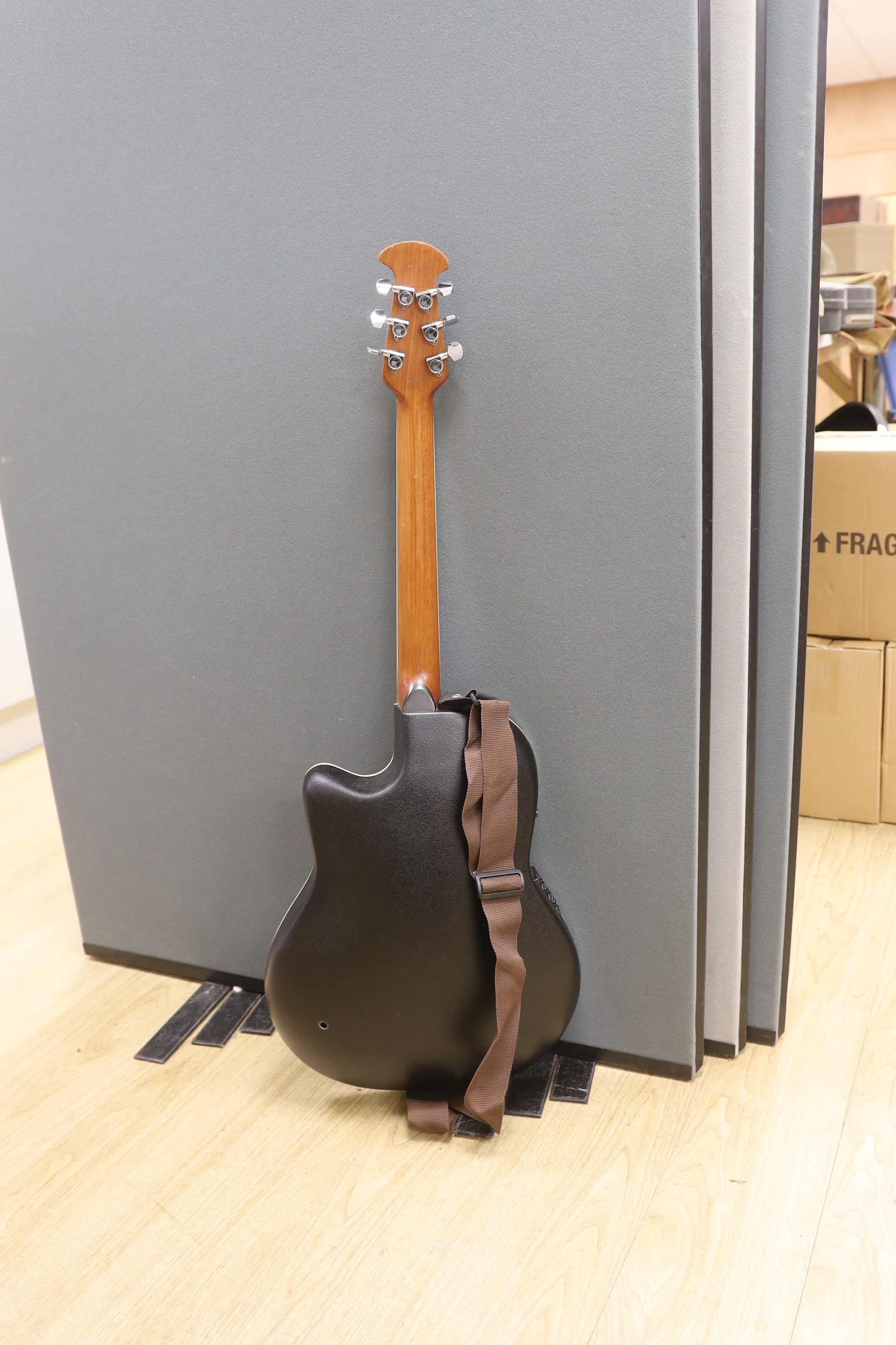A Celebrity by Ovation electro-acoustic round back guitar with hard case